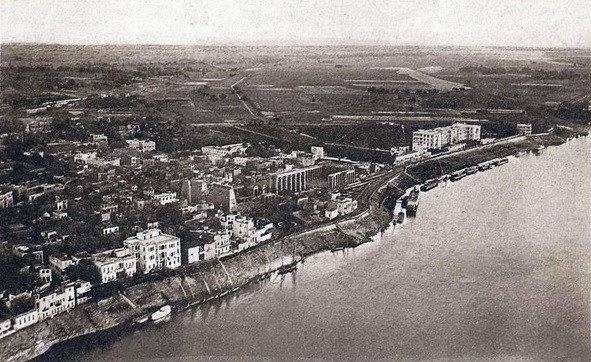 Vue aérienne historique du Winter Palace Hotel et des berges du Nil à Louxor, montrant les jardins de l'hôtel, les dahabiehs et les steamers au début du 20ème siècle